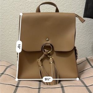 Never used caramel / brown leather backpack with two side pockets.